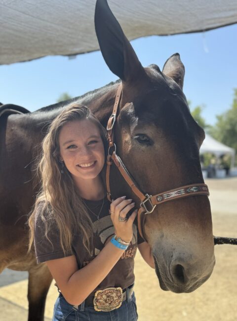 Abigail Lee, standing head to head with a charming mule.